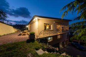 a house with a patio at night at Gîte Villa La Chèvrerie centre in Épinal