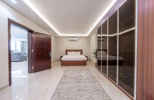 a hotel room with a bed and a large glass door at Mabaat - Almasarat Tower Al Shati - 531 in Jeddah