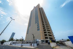 a tall building on the side of a street at Mabaat - Almasarat Tower Al Shati - 531 in Jeddah