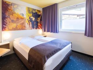 Giường trong phòng chung tại B&B Hotel Heilbronn