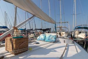 a boat with two pillows on the deck with other boats at Quo Vadis Yacht in Bari