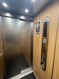 a elevator with a door with a remote control at Premiere Classe Rungis - Orly in Rungis
