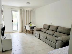 a living room with a couch and a table at Resort Home 10 in Sant Jordi