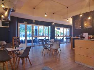 a restaurant with tables and chairs in a room at Foreshore Winks 407 in Cape Town