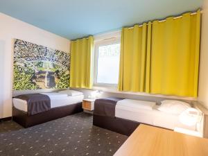Voodi või voodid majutusasutuse B&B Hotel Karlsruhe toas