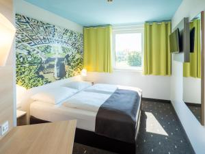 Tempat tidur dalam kamar di B&B Hotel Karlsruhe