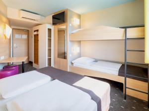 Voodi või voodid majutusasutuse B&B Hotel Karlsruhe toas
