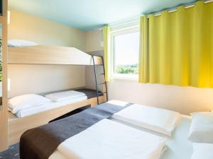 Voodi või voodid majutusasutuse B&B Hotel Karlsruhe toas