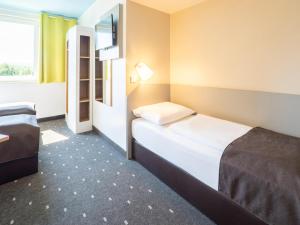 Voodi või voodid majutusasutuse B&B Hotel Karlsruhe toas