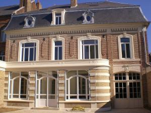 a large brick house with white doors and windows at The Gem in Amiens