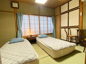 Postel nebo postele na pokoji v ubytování Guesthouse Imaichi ゲストハウス今市マチナカ
