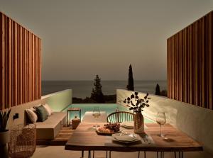 een woonkamer met een tafel en een bank bij The Sall Suites - Complex B in Agios Nikolaos