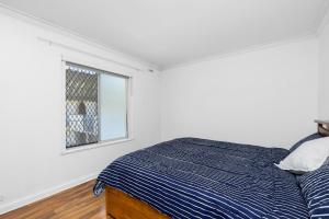a bedroom with a bed and a window at 10/17 Richardson Street, South Perth in Perth