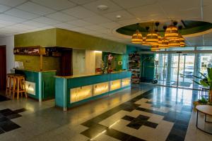 a lobby with a blue counter in a building at Hotel Venus in Zalakaros