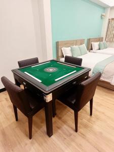 a room with a pool table and two chairs at W Cube in Tainan