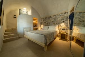 a bedroom with a bed and stairs in a room at Alaya Suites in Pirgos