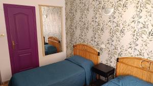 A bed or beds in a room at Alcaravaneras Hostel