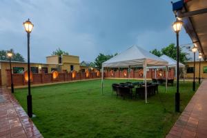 a group of tents on a lawn with lights at Hotel Ratnasambhava in Lumbini
