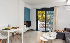 a living room with a white table and chairs at PROPAN CITY SUITES in Volos