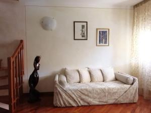 una sala de estar con un sofá blanco y una estatua en Da Francesca a Pisa, en Pisa