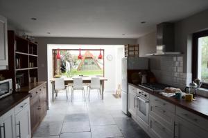 a kitchen with a table and chairs in it at Spring Cottage,Gorgeous and Hi-spec in Kilkhampton