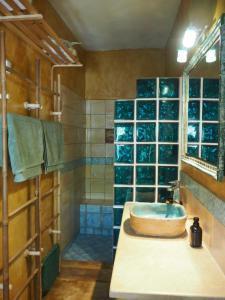 a bathroom with a sink and a glass wall at Artists' Residence 2 bed, 2 bath in Megalochori
