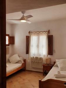 a bedroom with two beds and a window at Els Castells in Illes Balears