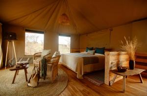 a bedroom with a bed in a tent at Olkeri Camp in Olmotoni