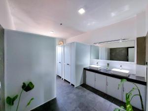 a bathroom with two sinks and a mirror at Catch Up Dambulla in Dambulla