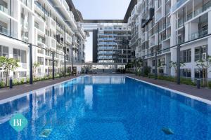 a large swimming pool in the middle of a building at Bloomfields Executive 1br In Oasis in Abu Dhabi
