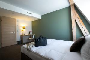 En eller flere senger på et rom på Hôtel des Voyageurs Boutique