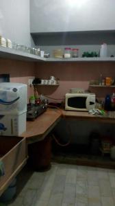 a kitchen with a counter with a microwave on it at Blue eye Backpackers Hostel in Amritsar