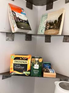 a shelf filled with books on a wall at Shaftesbury Centre in Shaftesbury