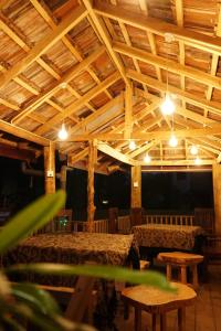 Una habitación con techos y mesas de madera y una cama. en Soul Inn, en Ahangama
