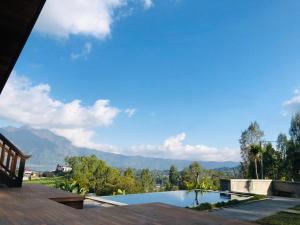 a swimming pool with a view of the mountains at Batur Cliff Panorama in Baturaja