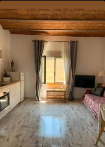 a living room with a bed and a window at BlauMasnou One step to the beach! in El Masnou