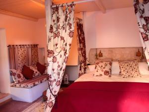 a bedroom with a bed and a chair at Artists' Residence 2 bed, 2 bath in Megalochori