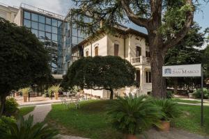 a building with a sign in front of it at Hotel San Marco Fitness Pool & Spa in Verona