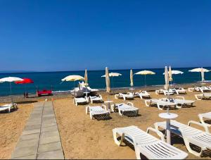 a bunch of chairs and umbrellas on a beach at Case Vacanze a Rossano in Rossano