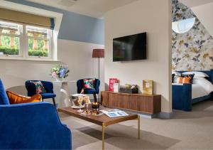 a living room with blue chairs and a tv at Dylan in Dublin