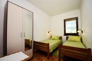 Postel nebo postele na pokoji v ubytování Apartments Tena