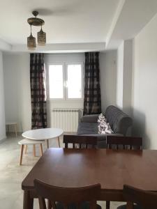 a living room with a couch and a table at Résidence Le Figuier Marako, Tizi-Gheniff in Tizi Gheniff