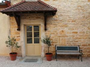 a bench in front of a building with a door at The Gate House & Winery in Santenay