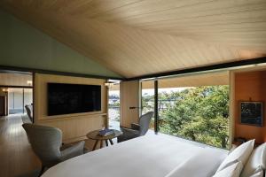 a room with a white table and chairs and a large window at Park Hyatt Kyoto in Kyoto