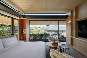 a bedroom with a bed and a large window at Park Hyatt Kyoto in Kyoto