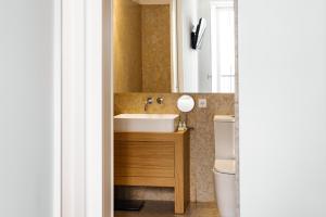 a bathroom with a sink and a toilet at The House on the Pink Street in Lisbon in Lisbon