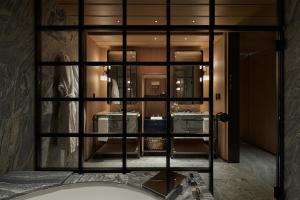 a room with a large glass window in a building at Park Hyatt Kyoto in Kyoto