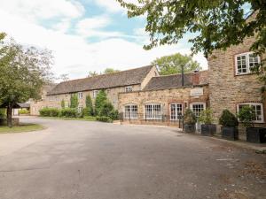 an empty driveway in front of a brick building at Brooke in Cottesmore