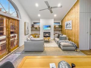 a living room with two couches and a ceiling fan at The Bail - Belmont/ Pet Friendly in Belmont