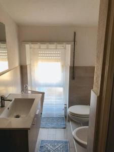 a bathroom with a sink and a toilet at Luis Apartment - Appartamento per single o coppia R7265 in Nuoro